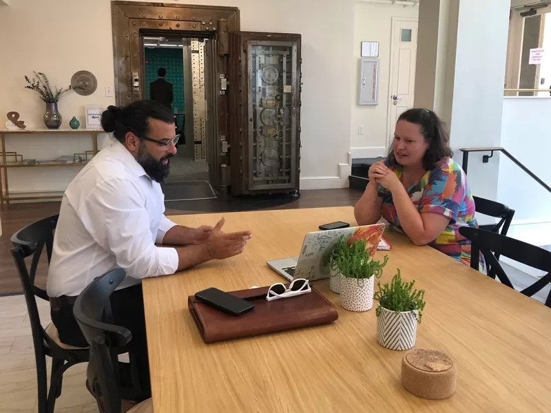 Momentum Services: two people sitting at table looking over laptop